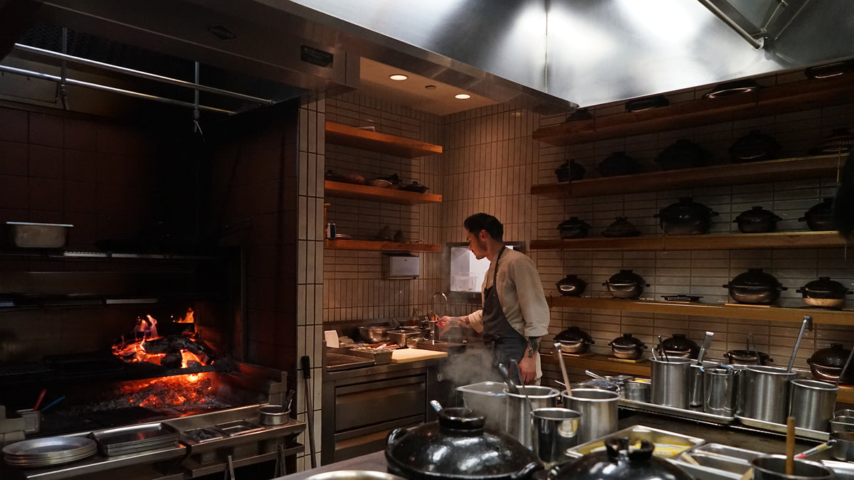 A cook working at the wood-fired hearth in the SingleThread kitchen, Healdsburg