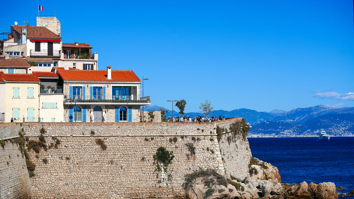 Stone ramparts and pastel seafront houses of Antibes old town above the Mediterranean, Côte d'Azur