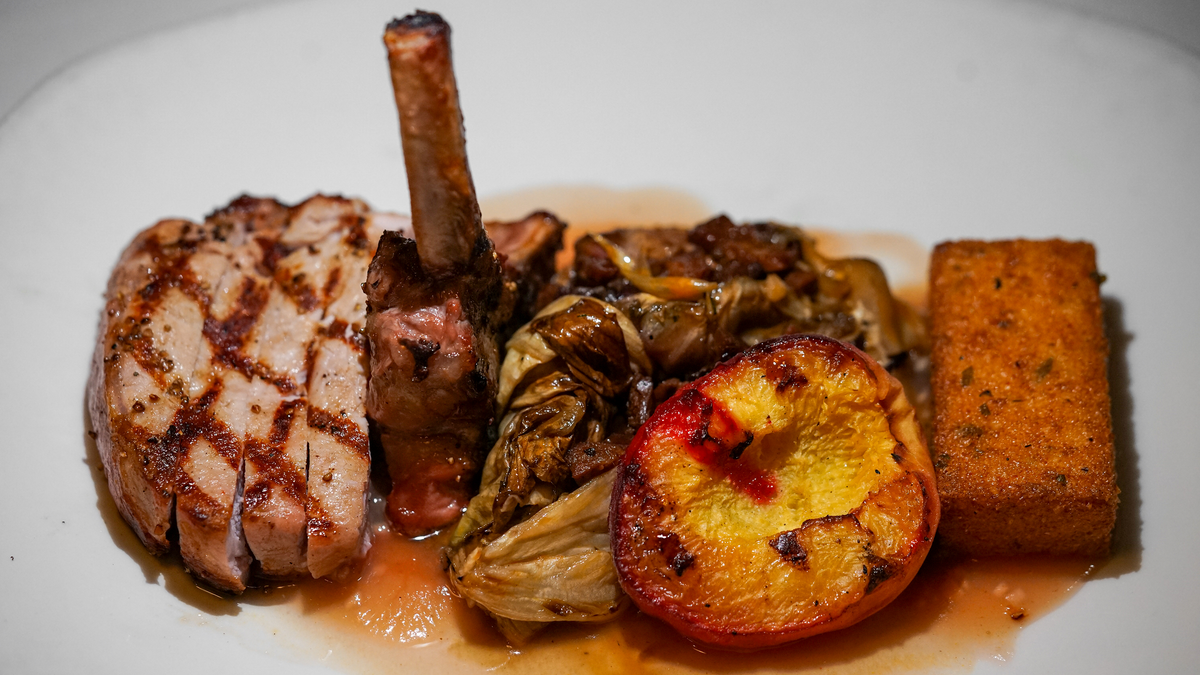 Grilled pork chop with a roasted peach half and grilled radicchio at Taste restaurant, Plymouth, Amador County