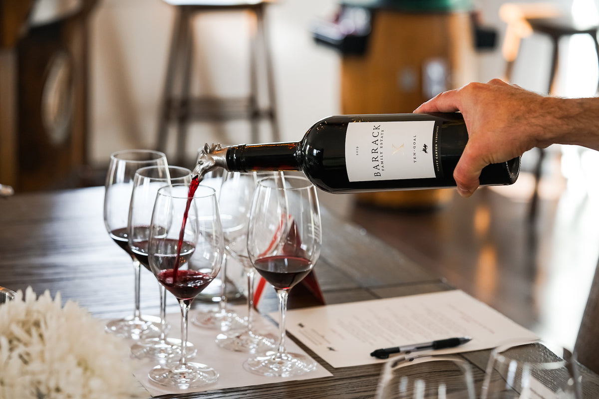 Pouring Barrack red wine into tasting glasses at the Happy Canyon Vineyards tasting room, Santa Barbara