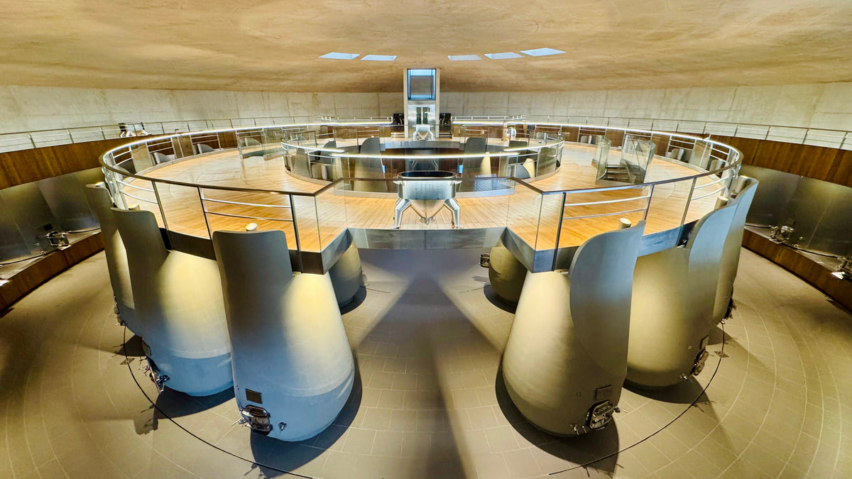 The circular concrete vat room with a glass-walled tasting platform at Château Haut-Bailly, Pessac-Léognan