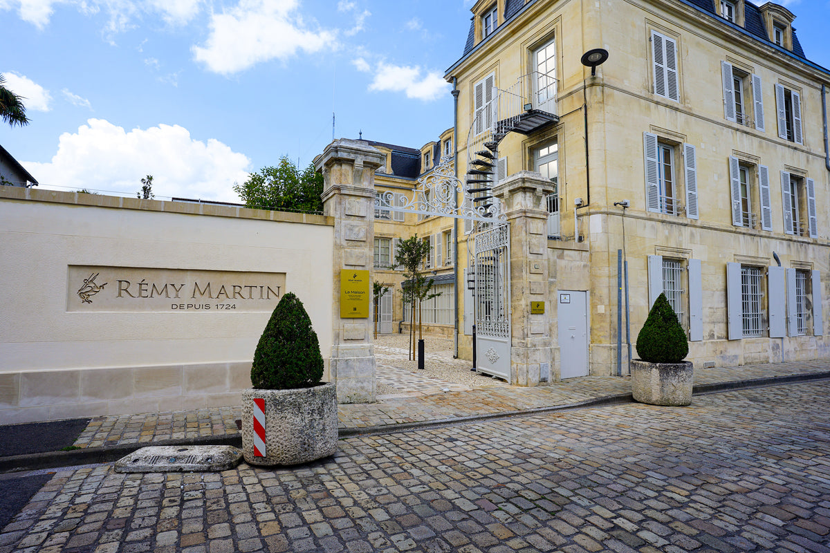 The Rémy Martin sign and stone entrance to the house's headquarters on a cobbled street in Cognac
